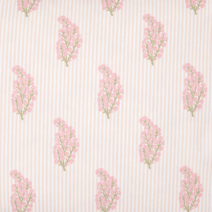 The Nirvi Lotus Bedding Collection by John Robshaw features pink and green floral sprigs in a charming block print style, repeating neatly over a beige and white subtly striped background.
