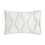 The Botanical Berries Bedding Collection by Gooselings features a rectangular white children’s pillow with a floral vine pattern of red and blue berries, finished with dark piping—ideal for sweet dreams.