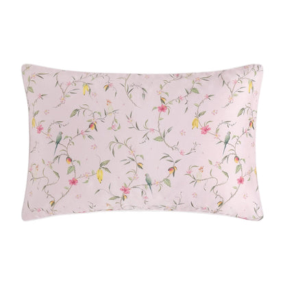 The Gooselings Dreaming of Paradise Toddler Pillow has a light pink background with pastel floral and bird patterns—an ideal choice for sweet dreams.