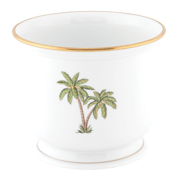 The Herend Palm Tree Decor Collection features a white ceramic planter with gold trim and a hand-painted illustration of two palm trees—a charming accent for any space.