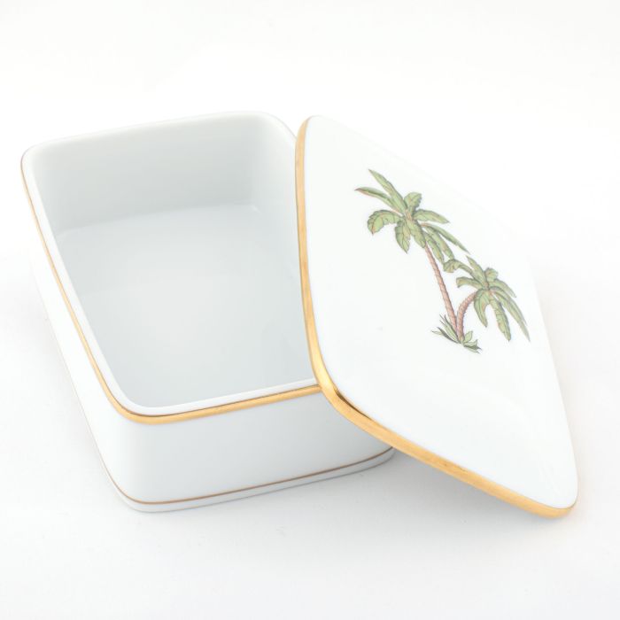 The Herend Palm Tree Decor Collection features a rectangular white porcelain box with a gold rim, hinged lid, and hand-painted palm tree illustration, shown partially open on a white background.
