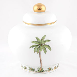 The Herend Palm Tree Decor Collection features a white porcelain jar with lid, hand-painted green palm tree, gold accents, and a gold knob—an elegant decorative accent for any space.