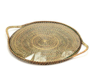 The Calaisio Round Serving Tray with Glass is a rustic modern tray featuring a tight woven rattan design, flat surface, spiral pattern, two side handles, and an elegant glass insert.