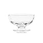 A clear glass footed dessert bowl from Juliska’s Puro Glass Serveware Collection, featuring textural lines and a round base with a wide opening. Shown on a white background with the text "Footed Dessert Bowl" below.