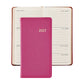 A 2027 Pocket Datebook by Graphic Image in pink rests atop an open weekly planner showing dates from July 12 to July 18, creating a delightful ensemble with a personal pocket journal perfect for organizing your schedule.