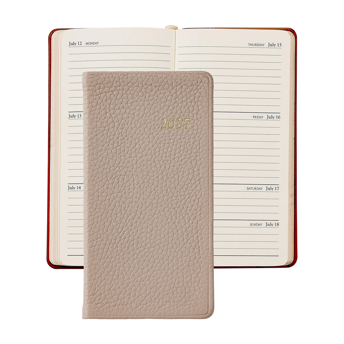 An open planner displays a week in July, topped with a closed Graphic Image 2027 Pocket Datebook in beige leather.
