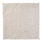 The Kim Seybert Silver & Gold Stamped Reversible Placemat, featuring a luxurious woven texture and zigzag cut edges, is displayed on a white background.