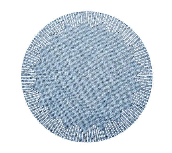 The Kim Seybert Dream Weaver Placemat is a round, blue placemat with a geometric starburst design and white-stitched edges—ideal for summer entertaining and stunning when seen from above.