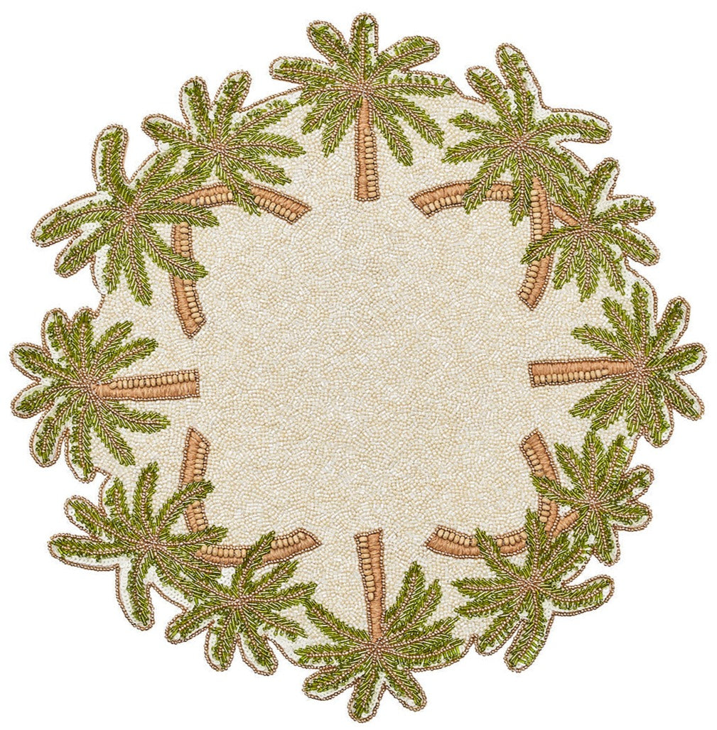 The Kim Seybert Oasis Placemat features a round, textured design with embroidered green palm trees and subtle beading, making it perfect for tropical entertaining.