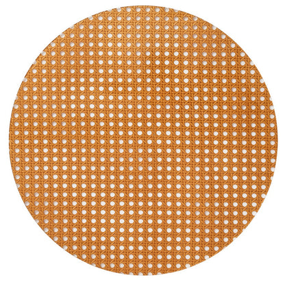 The Kim Seybert Reed Placemat features woven cane webbing with a hexagonal lattice pattern, offering a faux-wicker look that's ideal for outdoor entertaining on a white background.