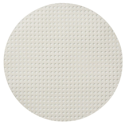 The Kim Seybert Reed Placemat features a round, flat design with a white, grid-like textured surface, resembling faux-wicker—ideal for stylish outdoor entertaining.