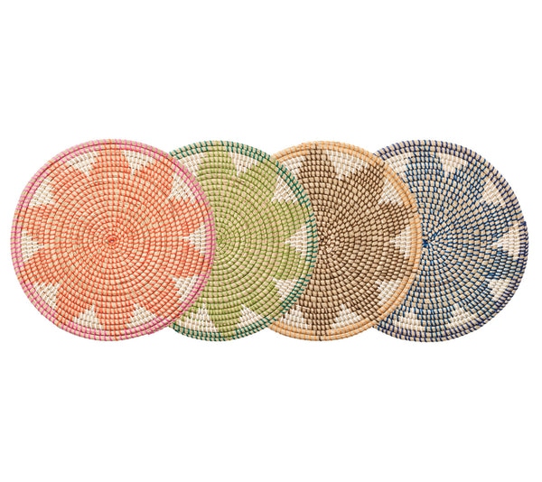 Four Kim Seybert Majorelle Placemats, adorned with geometric patterns in orange, green, brown, and blue, are crafted from natural seagrass. These woven pieces add an earthy touch and subtle floral motifs to any table setting.