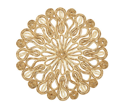 The Marisol Placemat Collection by Kim Seybert features circular woven table mats with intricate swirl and loop patterns in natural light brown fibers on a white background.