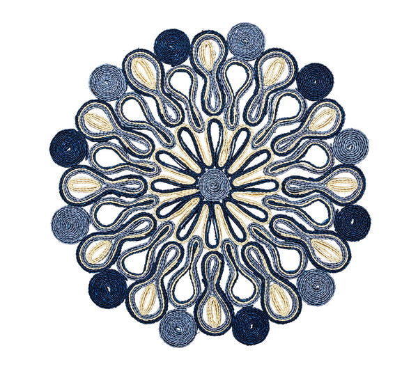 The Marisol Placemat Collection by Kim Seybert features blue and beige thread in circular patterns with loops, swirls, and radial designs on a white background.