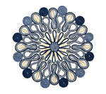 The Kim Seybert Marisol Placemat Collection features circular, symmetrical table mats with blue, navy, and beige woven loop and spiral patterns on a white background.