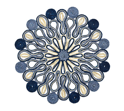 The Kim Seybert Marisol Placemat Collection features circular, symmetrical table mats with blue, navy, and beige woven loop and spiral patterns on a white background.