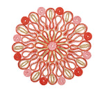 The Marisol Placemat Collection by Kim Seybert features circular mandala patterns with red, pink, and gold swirls on white, creating stunning artisan table mats perfect for elegant decor.