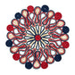Symmetrical mandala pattern of coiled string in red, blue, and beige evokes the artisanal style of the Kim Seybert Marisol Placemat Collection, displayed on a crisp white background.