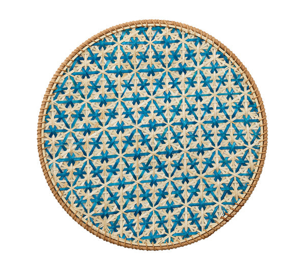 The Kim Seybert Lanai Placemat Collection features round woven lids with a blue and natural honeycomb motif, intricate patterns, and a sturdy rattan frame, all showcased against a white background.