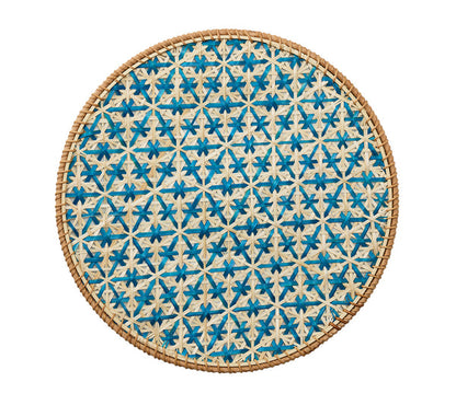 The Kim Seybert Lanai Placemat Collection features round woven lids with a blue and natural honeycomb motif, intricate patterns, and a sturdy rattan frame, all showcased against a white background.