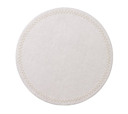The Starry Night Placemat Collection by Kim Seybert features a round, white textured placemat with a subtle stitched border and metallic trim, adding an elegant, easy-to-clean touch to any table setting.