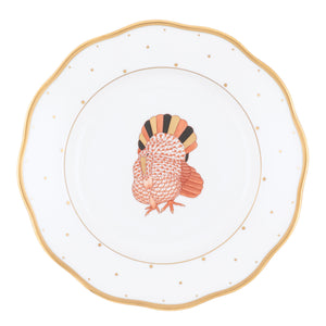 Add autumn charm to your table this harvest season with the Herend Fall Dessert Plate, featuring a white base accented by a gold rim, delicate gold dots, and a central illustration of a turkey.