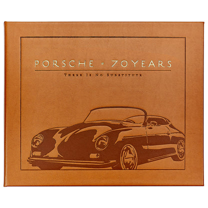 A leather-bound book cover by Graphic Image, titled "Porsche 70 Years: There is No Substitute," featuring a vintage Porsche illustration and chronicling automotive history as detailed by Randy Leffingwell.