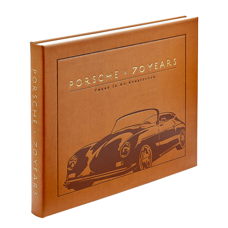 The "Porsche 70 Years: There is No Substitute" by Randy Leffingwell is a brown hardcover book from Graphic Image, featuring an embossed illustration of a classic Porsche car on the cover. This exquisite piece delves into Porsche's rich automotive history.