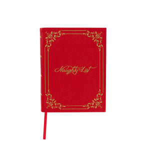 The Juliska Naughty/Nice Embossed Journal features "Naughty List" in gold script with a gold border on ruby red vegan leather, plus a matching red ribbon bookmark.