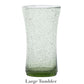 A tall, slightly flared light green tumbler from Juliska’s Provence Basil Drinkware Collection features a textured, bubble-filled surface reminiscent of effervescent glassware; labeled "Large Tumbler" below.