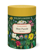 The Cavallini Papers and Co Mini 240 Piece Puzzles come in a cylindrical box with vibrant wildflower illustrations on a dark green background—an ideal gift or relaxing activity for nature lovers.
