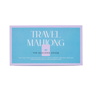 The Mahjong House Travel Mahjong Set comes in a blue and purple rectangular box with white product details, featuring lightweight tiles perfect for gaming on the go.