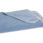The Paley Cashmere Throw by Matouk, in light blue Mongolian cashmere with a fringed edge, is shown folded on a white background.