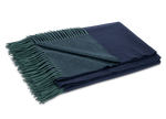 The Matouk Paley Cashmere Throw, a folded reversible design in navy blue and dark green with green fringed edges, is shown on a plain light background.