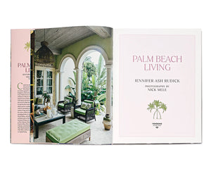 Open book displaying "Palm Beach Living" by Vendome; left page shows a stylish, plant-filled patio with arched columns and lounge furniture, evoking tropical luxury and design excellence.