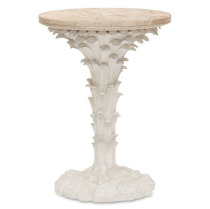 The Palm Drinks Table by Bunny Williams features a round cream stone top with a white sculpted base, elegantly designed to resemble stylized leaves and rocks.