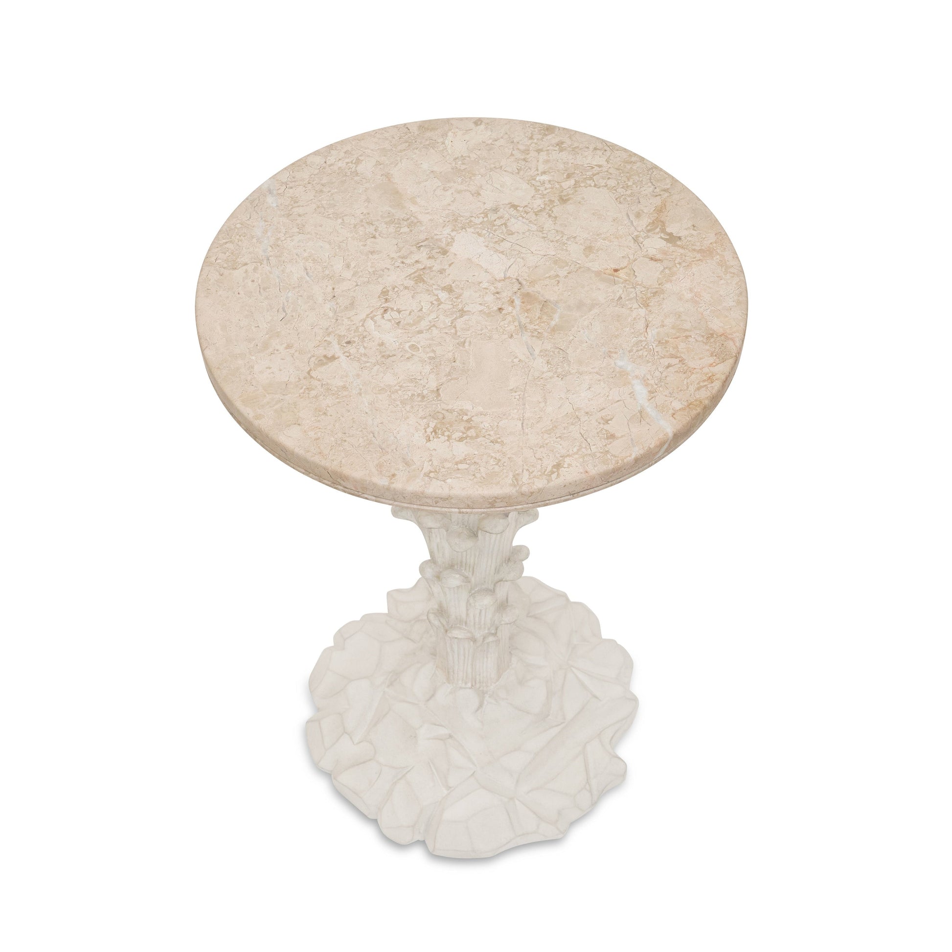 The Palm Drinks Table by Bunny Williams features a cream stone round top and a sculpted white base with intricate, organic detailing.