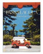 The Assouline book "Passalacqua: A Love Letter to Lake Como" features a cover with a small red car by palm trees in the hotel garden, overlooking the tranquil lake and mountains.