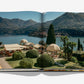 An open book, Passalacqua: A Love Letter to Lake Como by Assouline, reveals a photograph of the luxury Italian estate with striped cabanas, manicured gardens, and mountains in the background.
