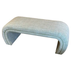 The O'Neal Bench in Rita Menthe by McCann Design Group features a rectangular upholstered form with rounded edges, arched legs, and an elegant design in a chic light gray fabric.