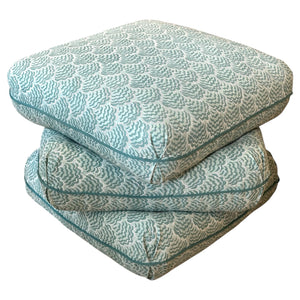 Two Ashley Ottomans in Jhinuk Teal by Sherrill/Mr & Mrs Howard are stacked against a white background—their teal and white pattern ideal for sophisticated interiors.