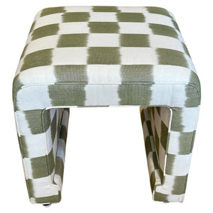 The Willow Ottoman by Century Furniture features open sides and is upholstered in a green and white checkered fabric, combining exceptional quality with refined elegance.