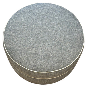 The Lee Industries Ottoman in Rosmar Blue features a round design, gray-blue fabric with visible stitching, and a subtle textured pattern—making it a stylish accent for any elegant décor.