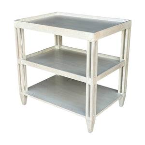 The Rennie’s Side Table by Sherrill/Mr & Mrs Howard is a light-colored wood piece with natural texture, three shelves, and tapered legs, shown against a white background.