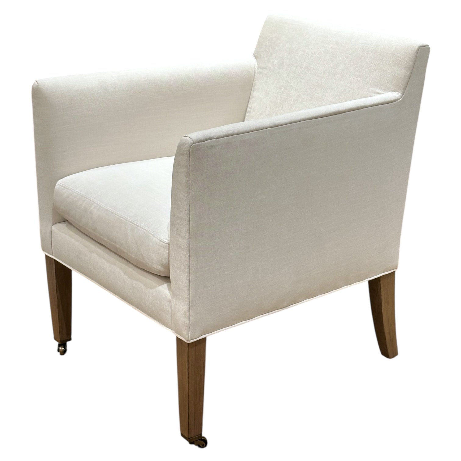 The Lee Industries Arm Chair on Casters features white upholstery, square arms, wooden legs, and front caster wheels, photographed against a plain white background.