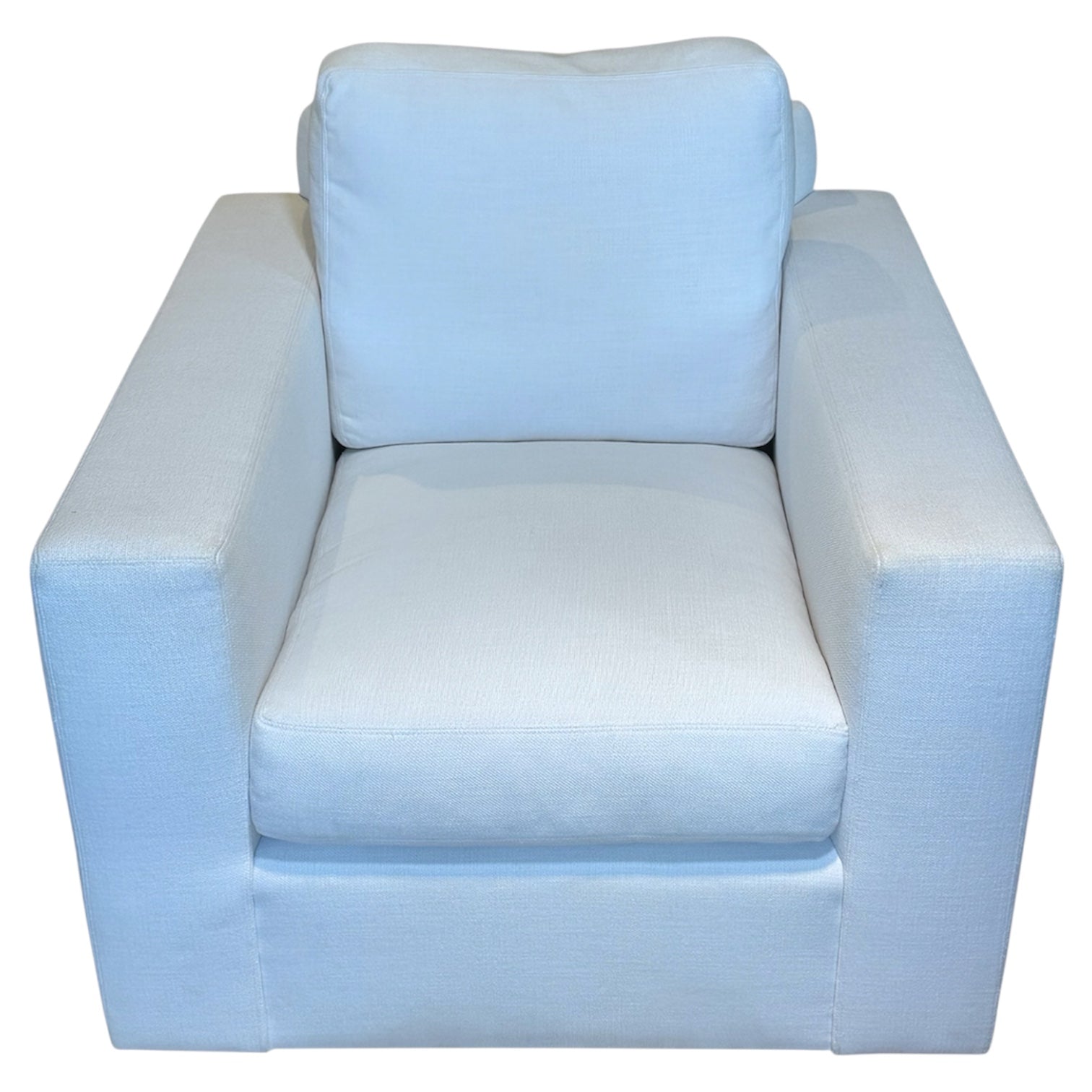 The Gregoire Swivel Chair by Verellen is a modern, boxy armchair with light blue upholstery, wide armrests, a thick back cushion, and an 8-way hand-tied seat made from sustainably harvested hardwood.