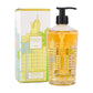 A Baobab Collection Miami Body Wellness hand wash gel with a pump dispenser is displayed beside its decorative box adorned with colorful building designs, capturing the vibrant Miami scent in a fresh sea salt fragrance.