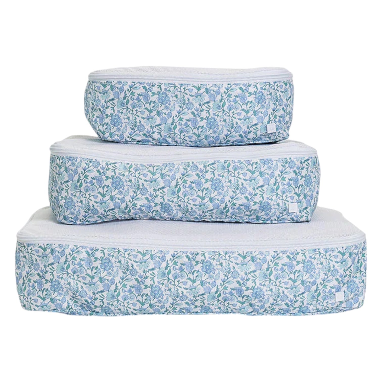 The Luxe Packing Cube Set of 3 by TRVL Design features rectangular bags with blue floral patterns, stacked on a white background—ideal for keeping your lightweight luggage neat and organized.