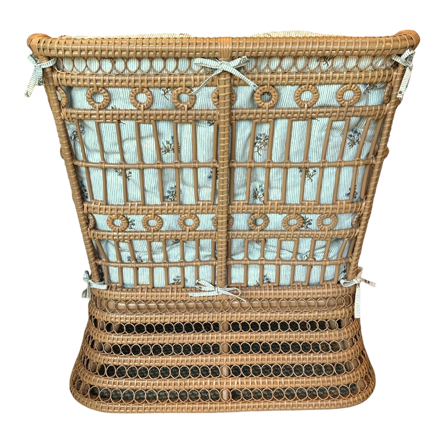 Rear view of the Bunny Williams Kinley Arm Chair, highlighting its wicker artistry, decorative woven pattern, and light blue striped cushion secured to the frame.