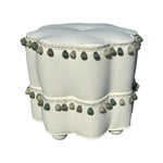 The Bunny Williams Stella Stool with Trim features white and green upholstery, serving as a stylish pouf or cozy footrest to complement any modern space.